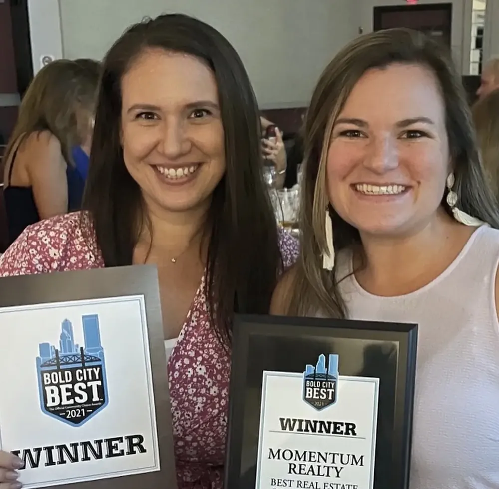 Brittany Brooks and Michelle Weaver winning Bold City Best Real Estate Brokerage award for Momentum Realty